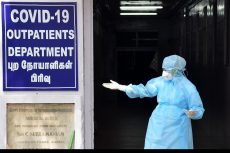 A frontline worker standing in front of a Chennai Covid ward