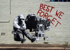 Graffiti with red spray paint saying 'Best We Forget'